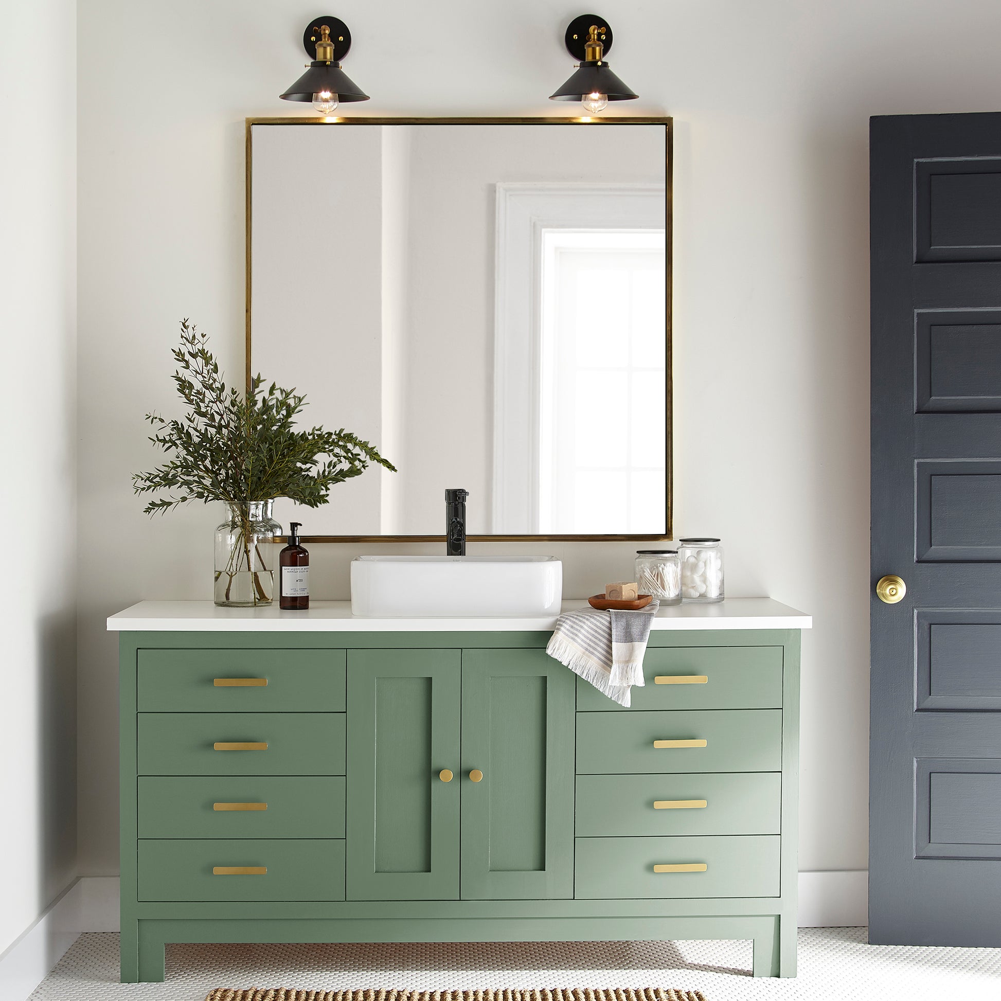 Bold and crisp green trim, door and cabinetry paint named Magnolia Green shown painted onbathroom cabinet