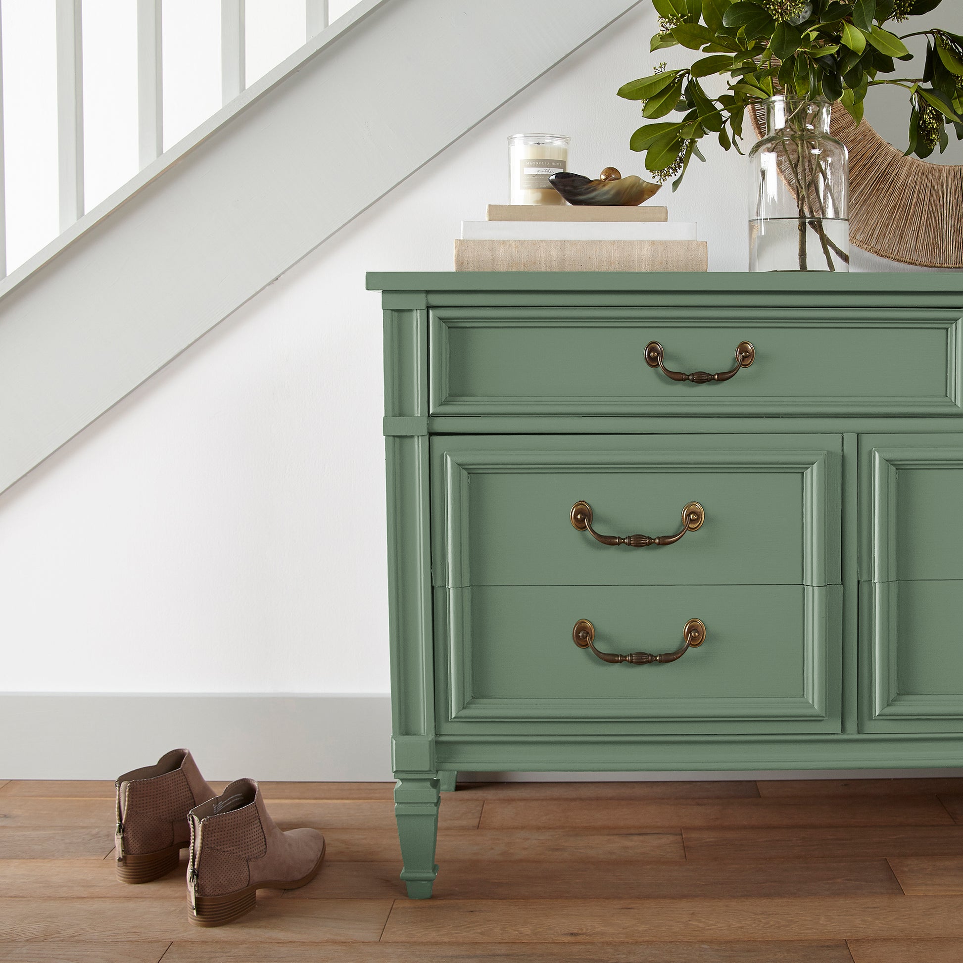 Bold and crisp green trim, door and cabinetry paint named Magnolia Green shown painted on entryway cabinet