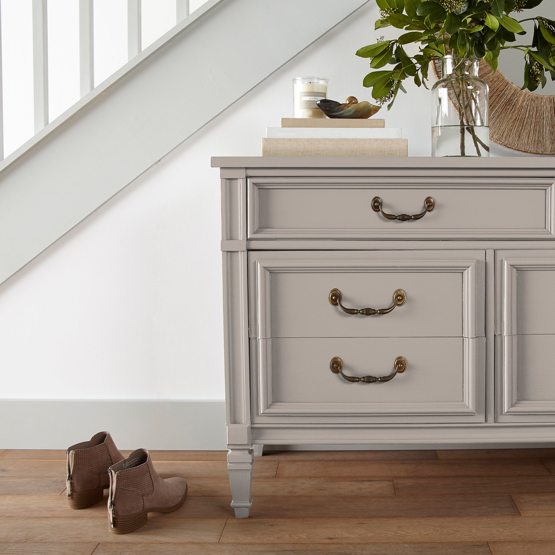 Sandy tan with pink door and cabinet paint named cinnamon sugar shown painted on entryway cabinet