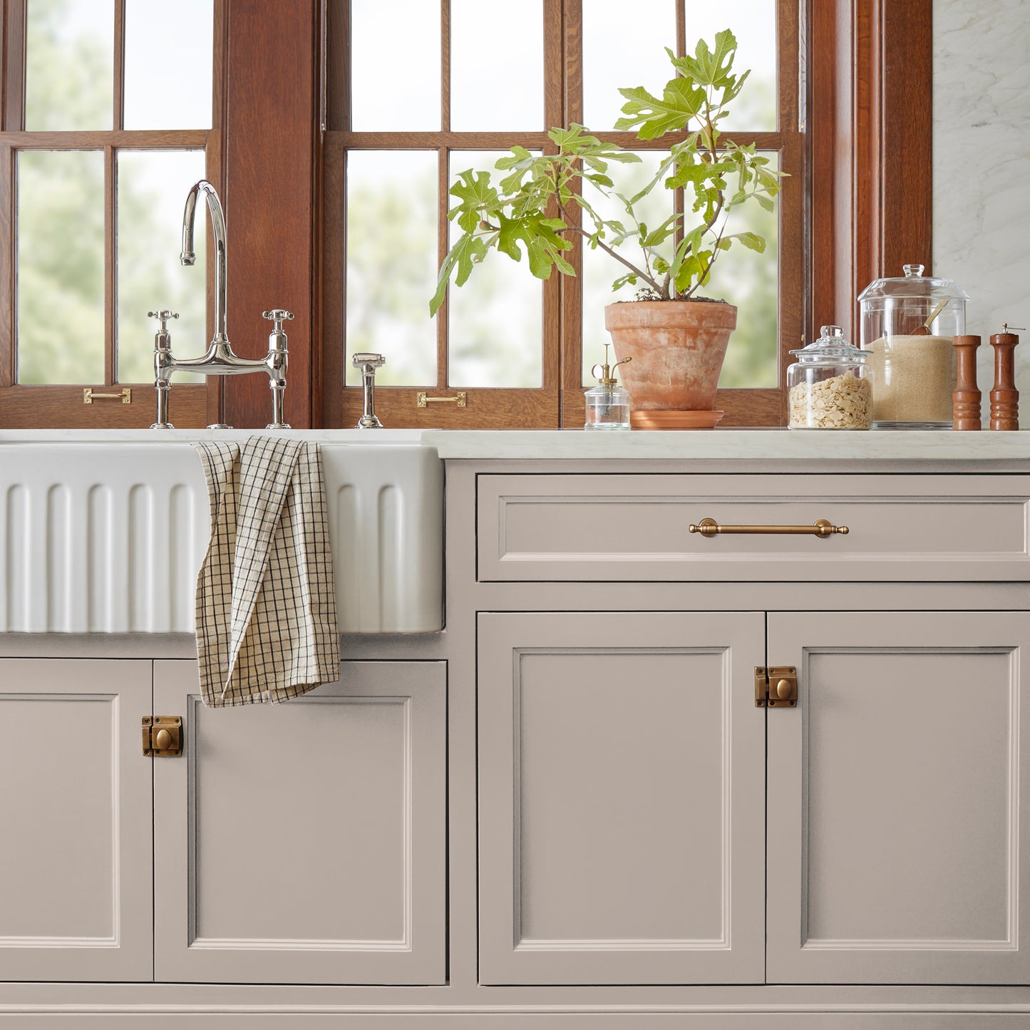 Sandy tan with pink door and cabinet paint named cinnamon sugar shown painted on kitchen cabinet