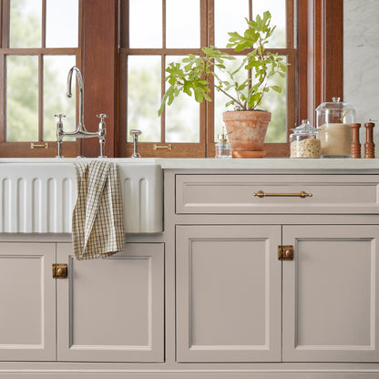 Sandy tan with pink door and cabinet paint named cinnamon sugar shown painted on kitchen cabinet