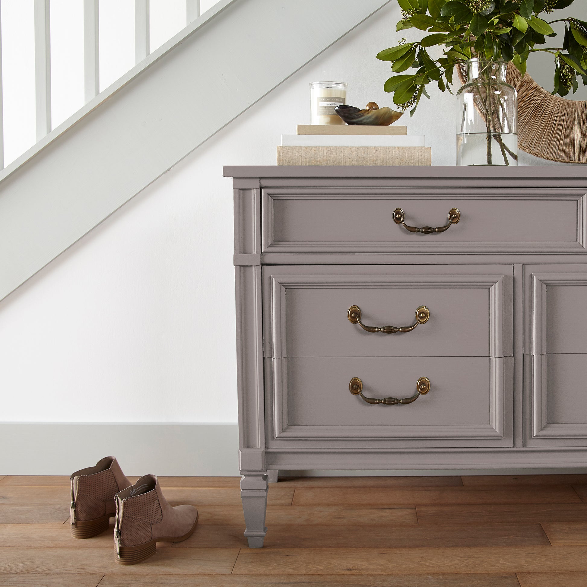  A mid-tone mauve  door and cabinet paint named homebody shown painted on entryway cabinet