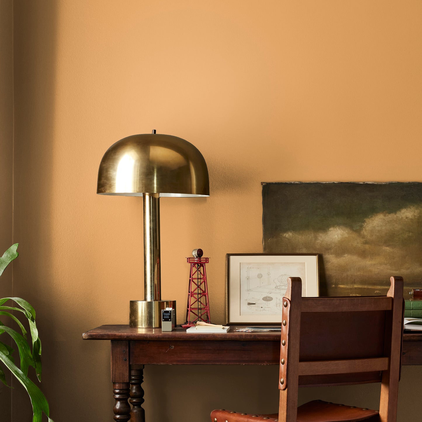 Rich ochre yellow interior paint named brushed clay shown painted on bedroom wall
