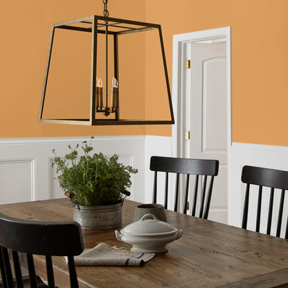Rich ochre yellow interior paint named brushed clay shown painted on dining room wall