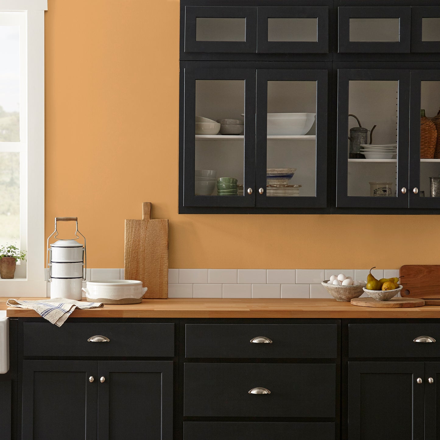 Rich ochre yellow interior paint named brushed clay shown painted on kitchen wall