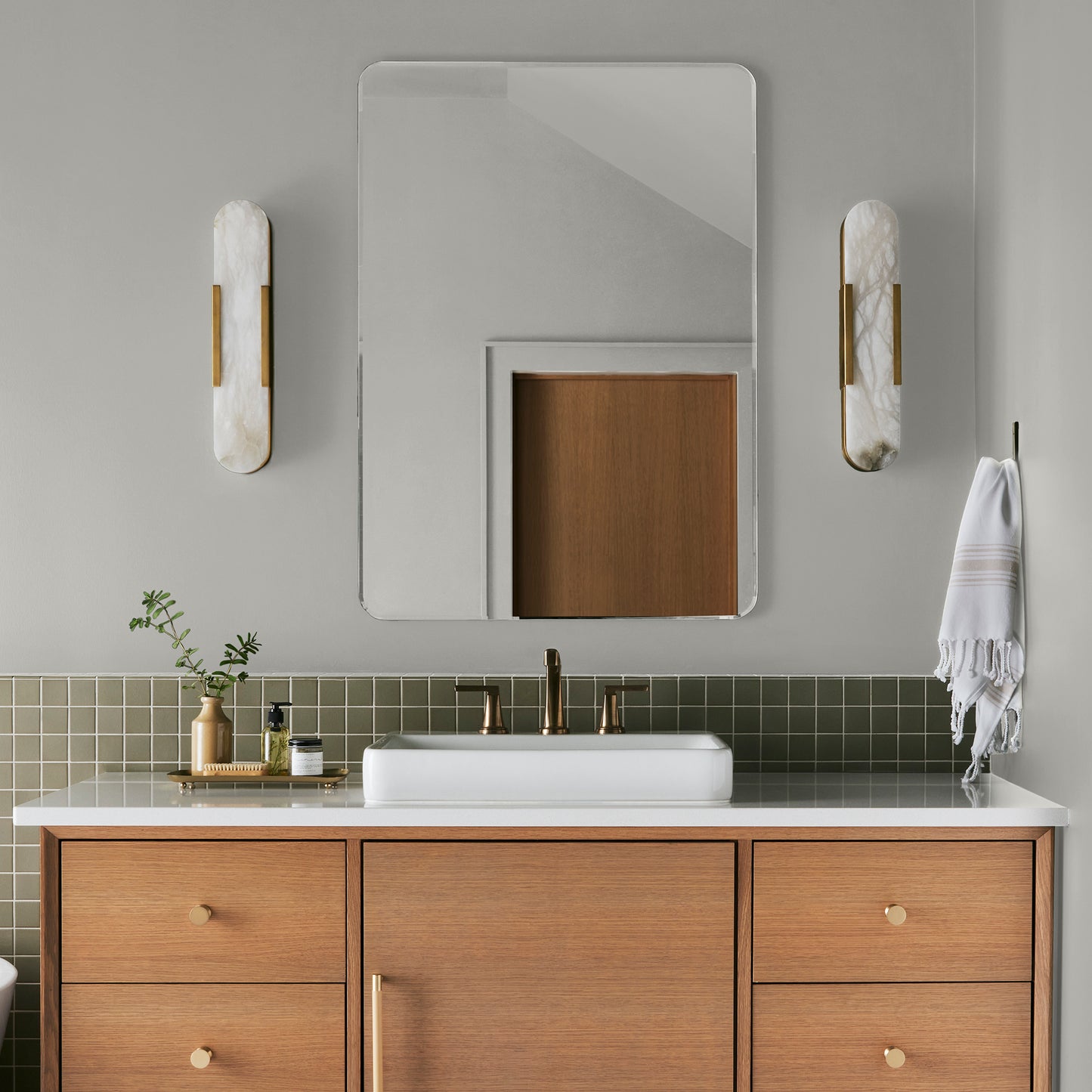 Light gray with green undertone paint named piece of cake shown painted on bathroom wall