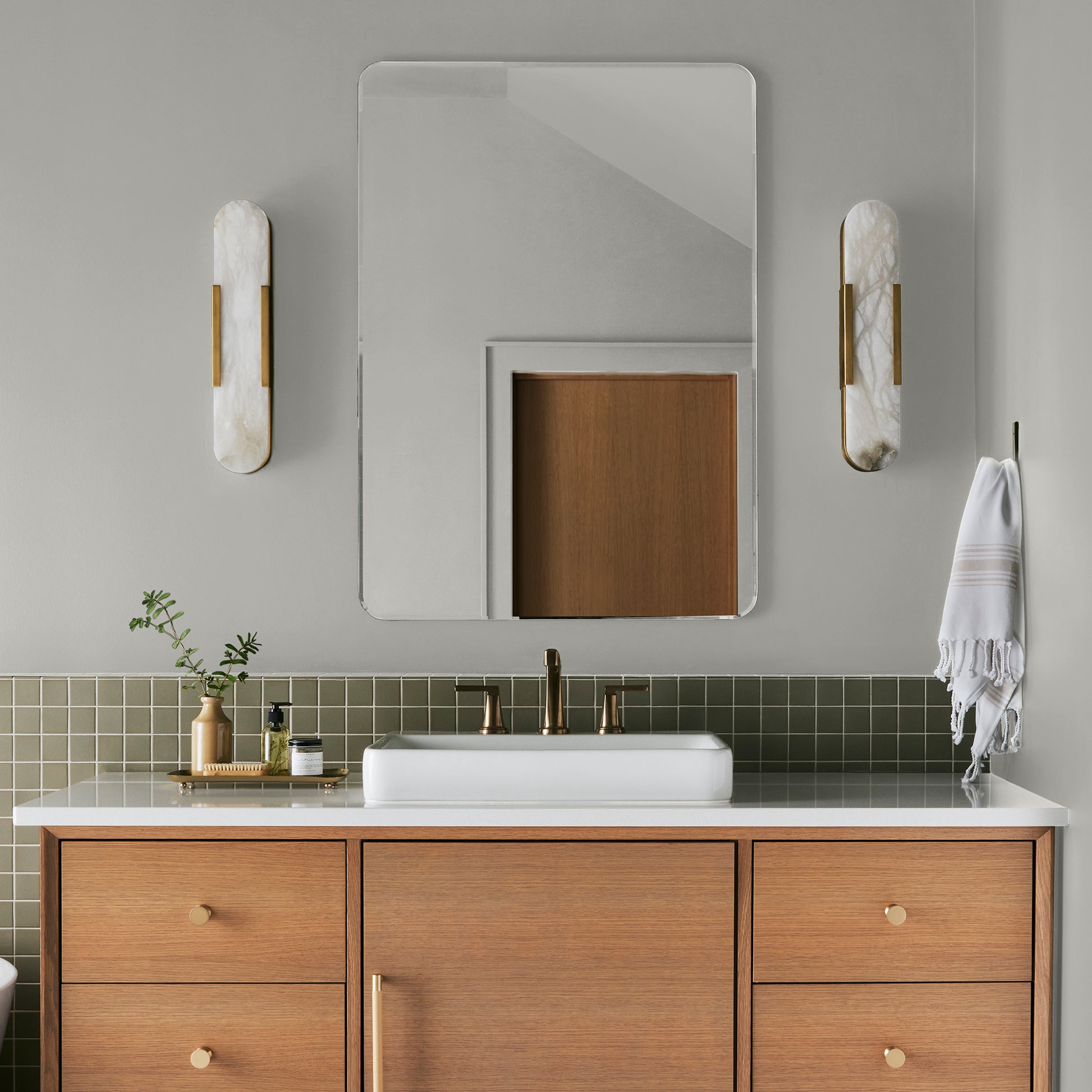 Light gray with green undertone paint named piece of cake shown painted on bathroom wall