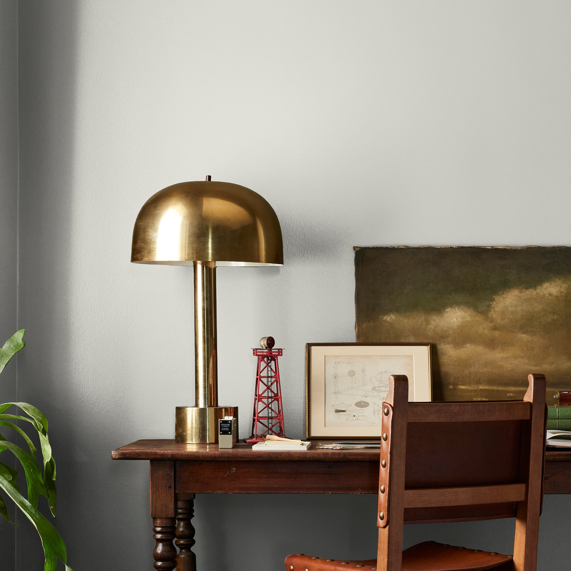 Light gray with green undertone paint named piece of cake shown painted on bedroom wall