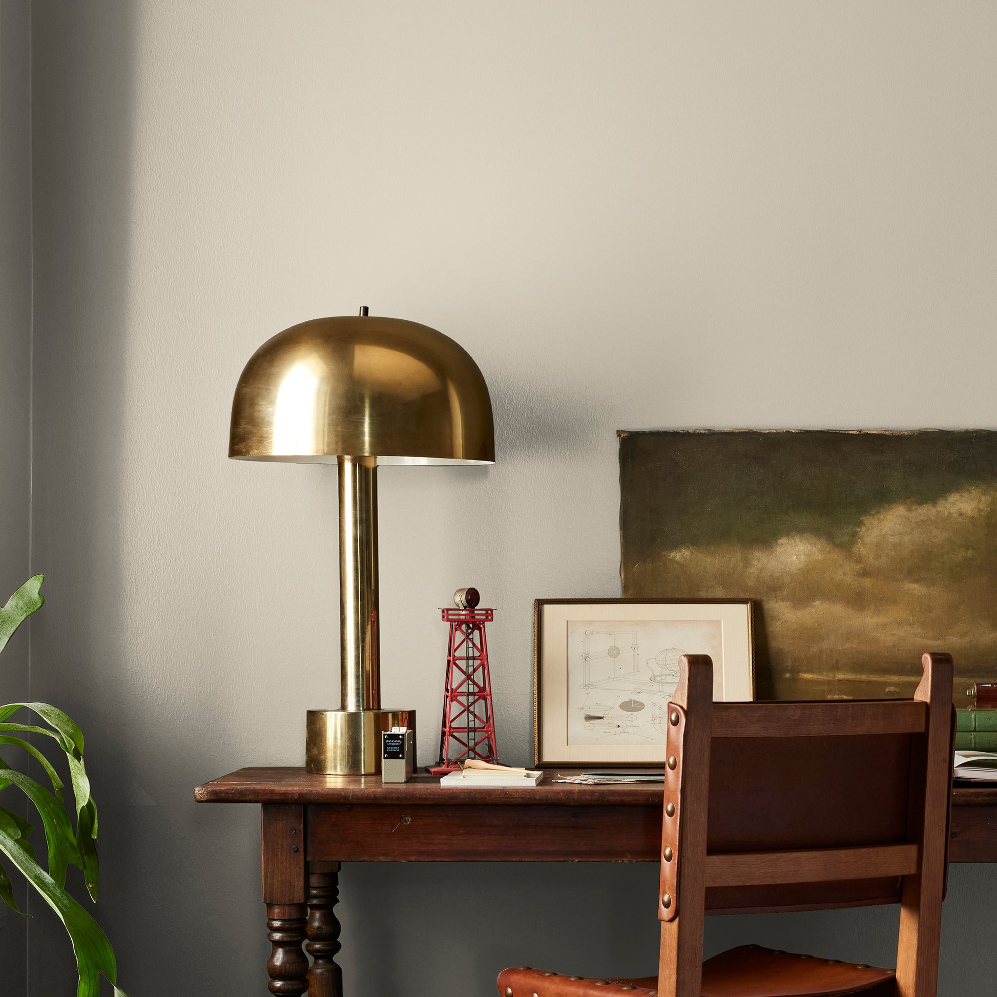 A light khaki green interior paint named summer hay shown painted on bedroom wall