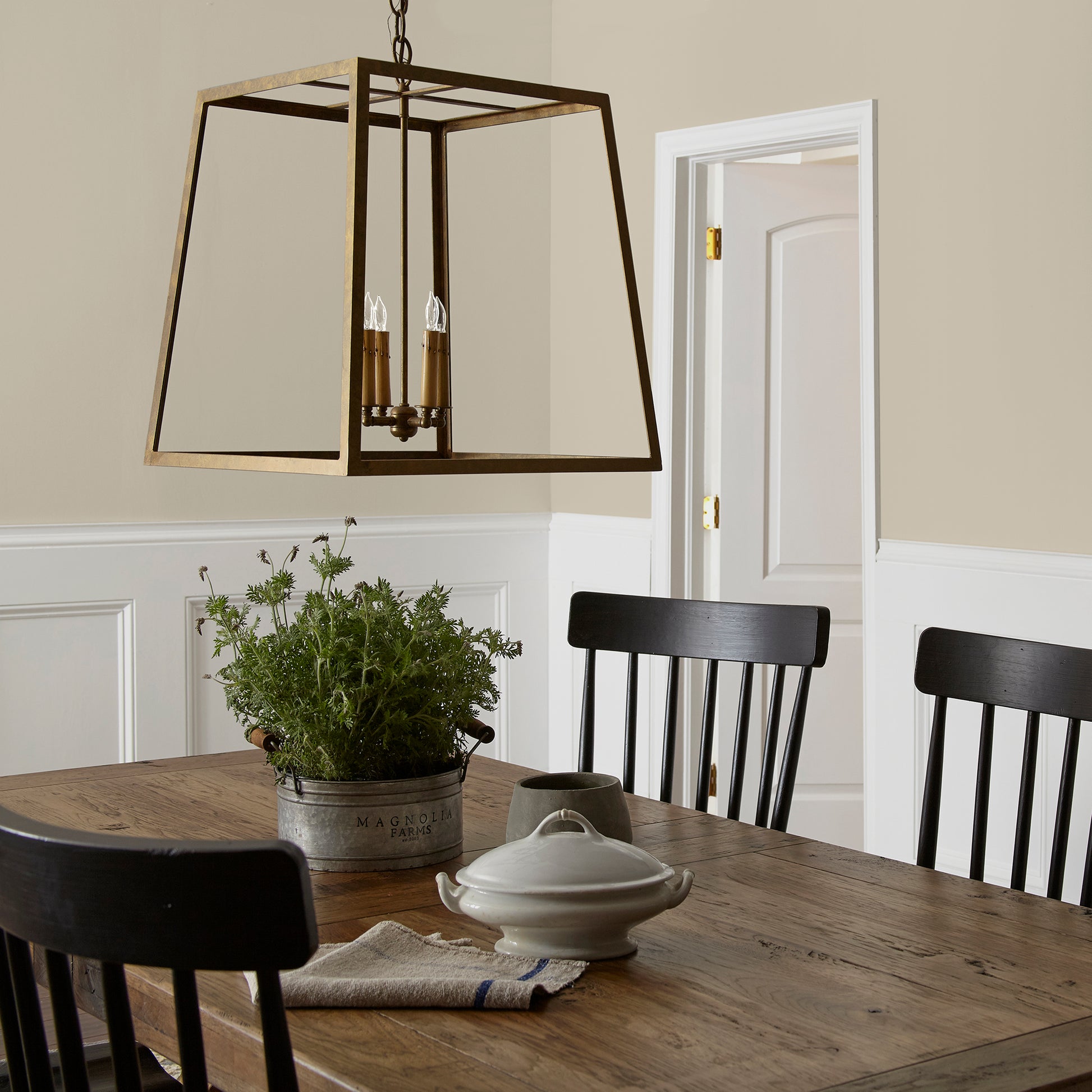 A light khaki green interior paint named summer hay shown painted on dining room wall
