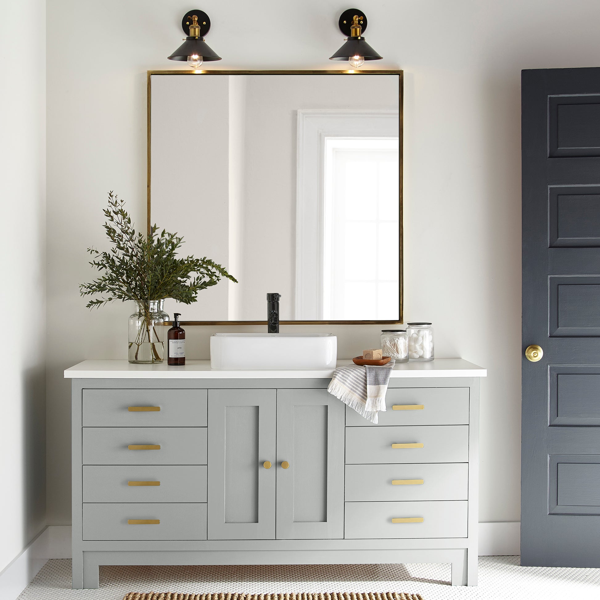 Soft light gray with blue undertone door and cabinet paint named dark moon shown painted on bathroom cabinets