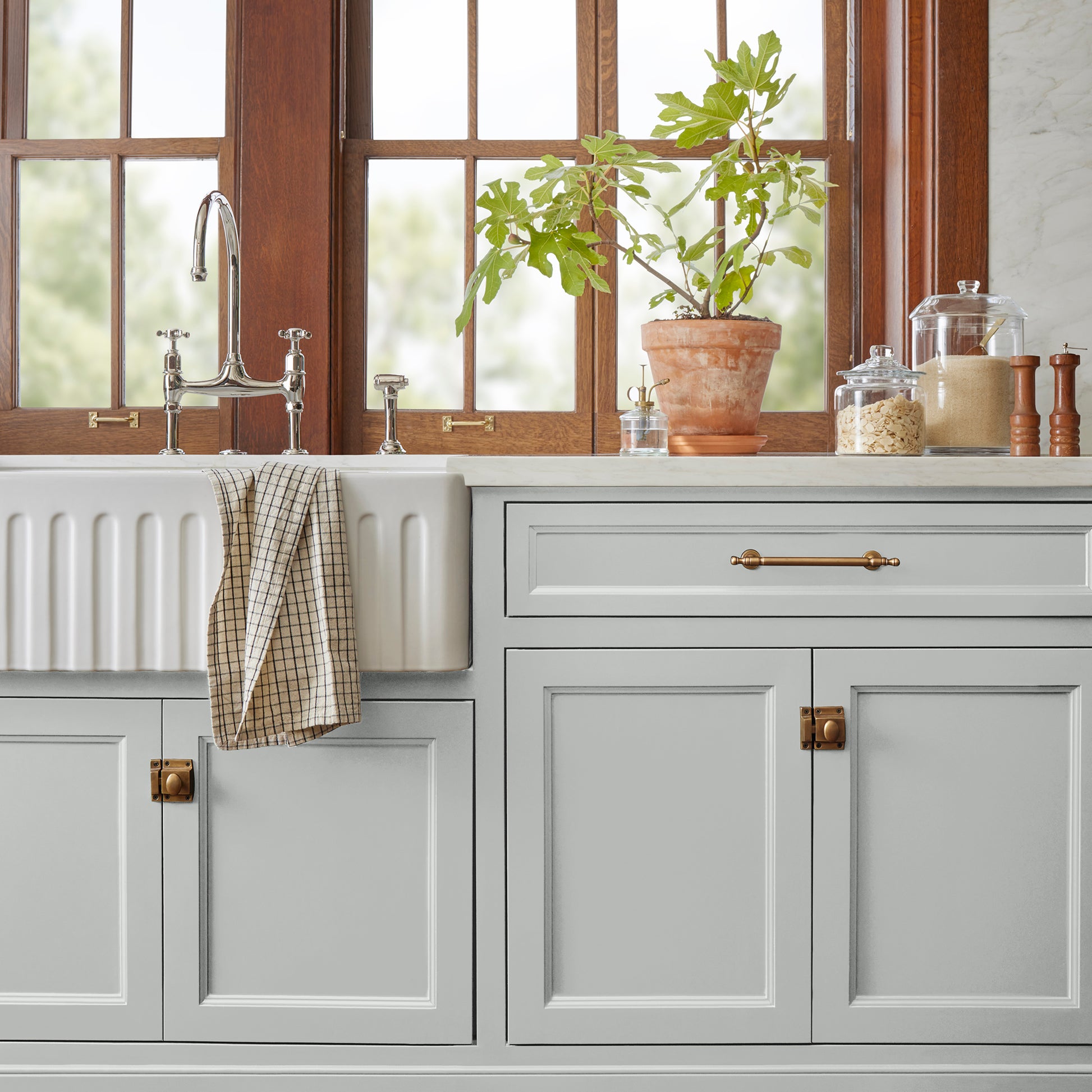Soft light gray with blue undertone door and cabinet paint named dark moon shown painted on kitchen cabinets