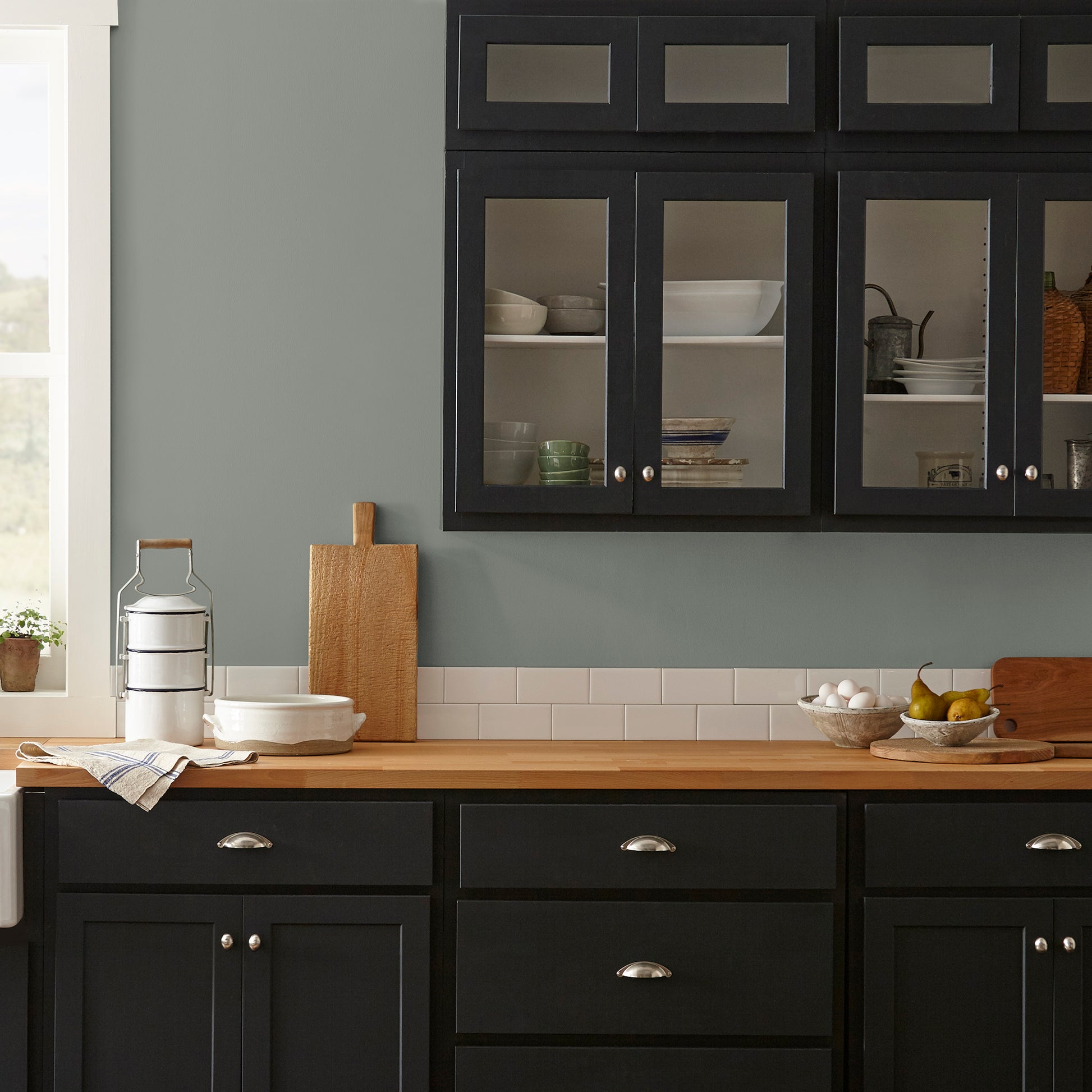 Medium sage green interior paint named sage stem shown painted on kitchen wall