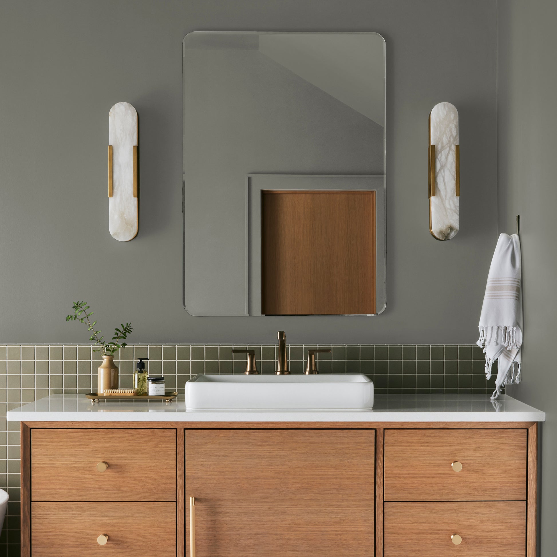 dark gray with olive green undertone paint named boutique gray shown painted on bathroom wall