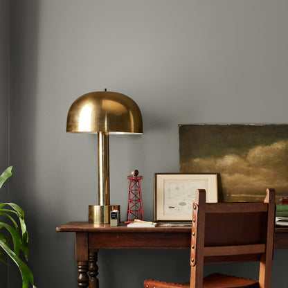 dark gray with olive green undertone paint named boutique gray shown painted on bedroom wall