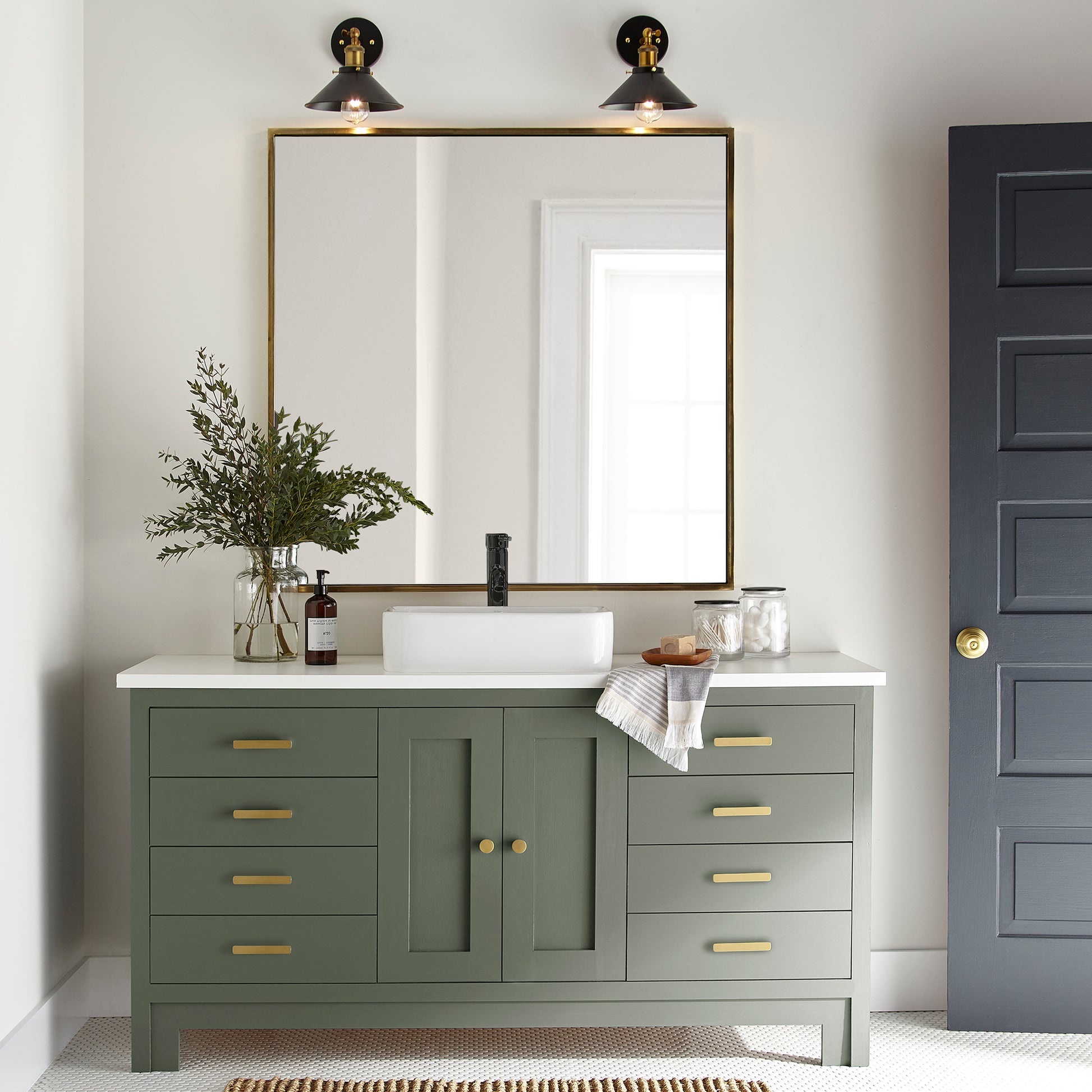 Dark and rich sage green door and cabinet paint named lemon leaves shown painted on bathroom cabinet