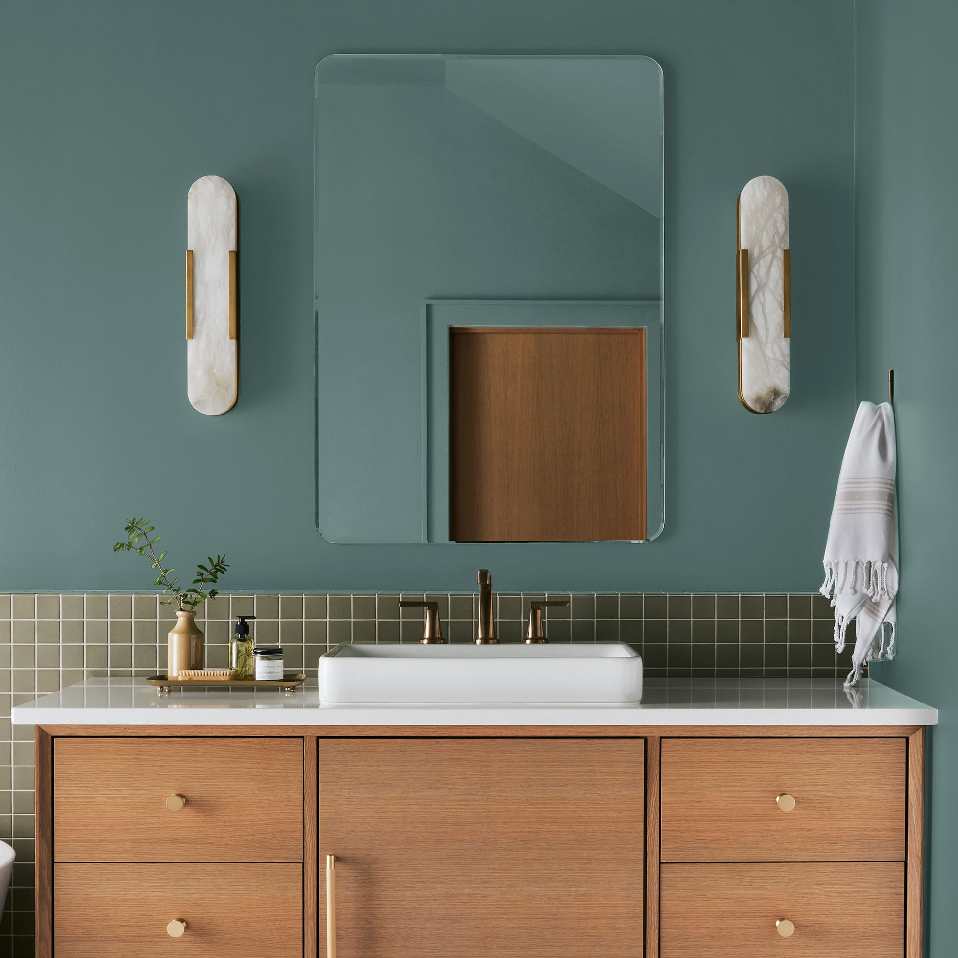 A dark, dusty aqua interior paint named tranquility shown painted on bathroom wall