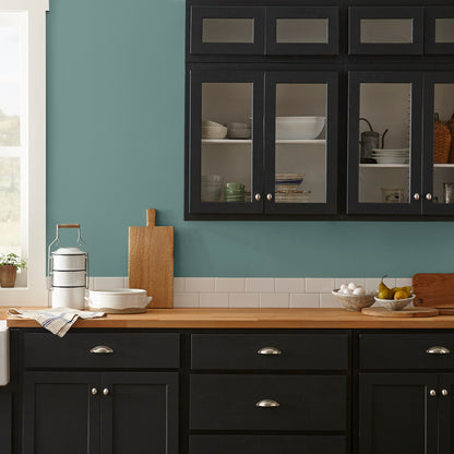 A dark, dusty aqua interior paint named tranquility shown painted on kitchen wall