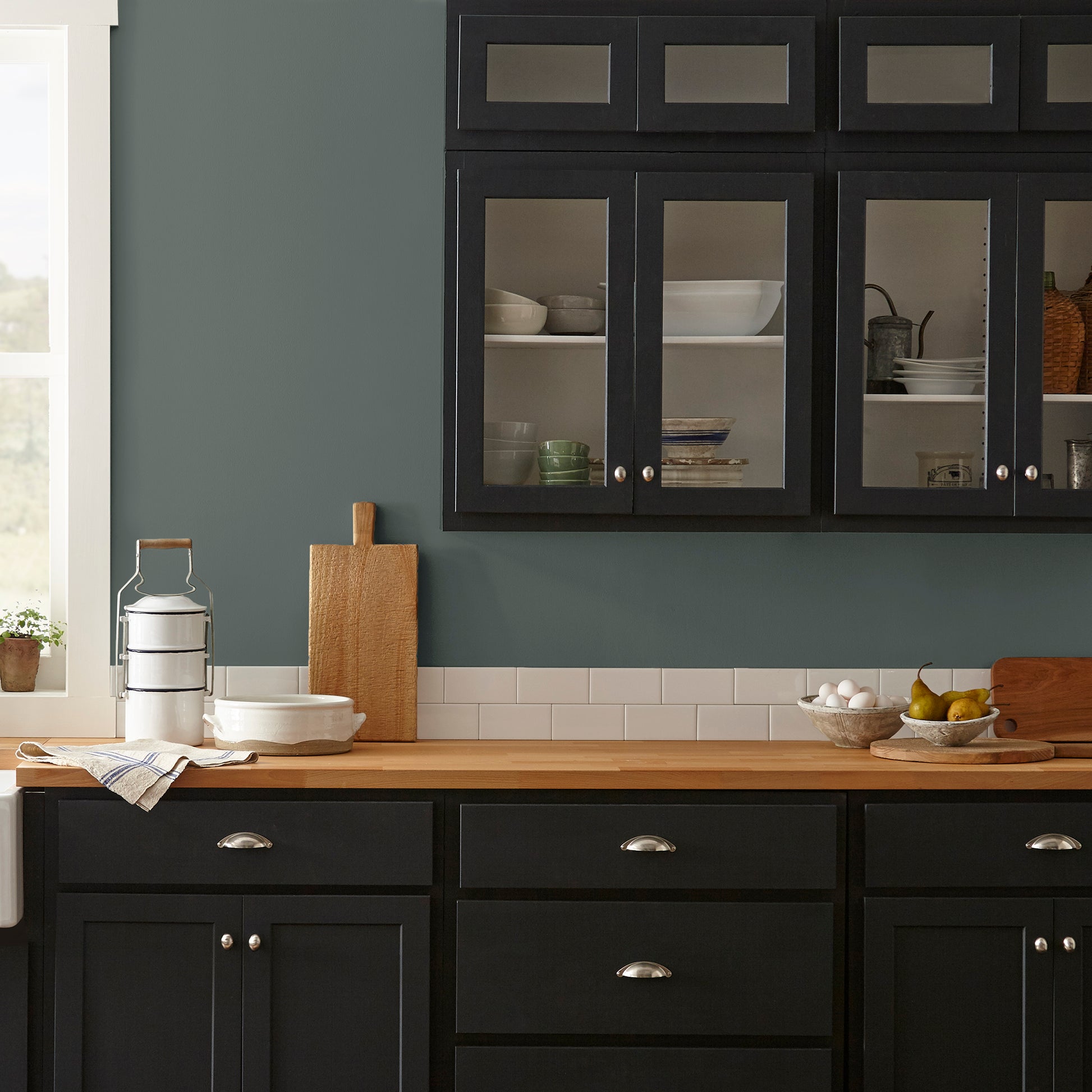 A slightly jeweled forest green hue classic interior paint named 1905 shown painted on kitchen wall