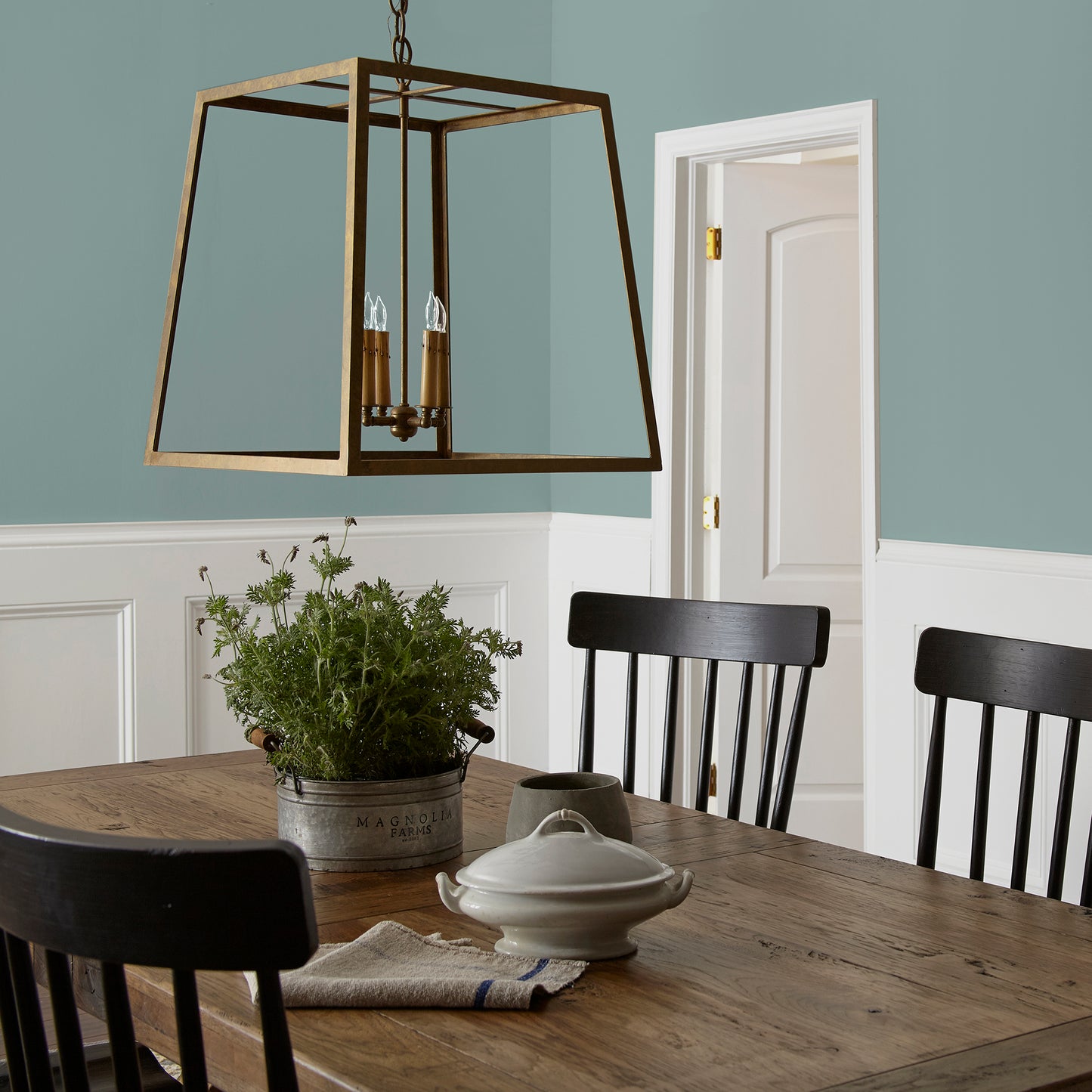 Ashy green with aqua undertone interior paint named well watered shown painted on dining room wall