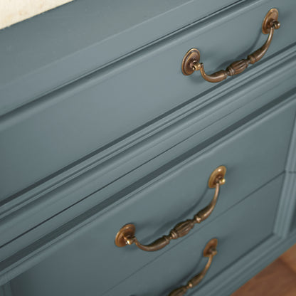 A grayed out blue door and cabinet paint named storm chaser shown painted on cabinet