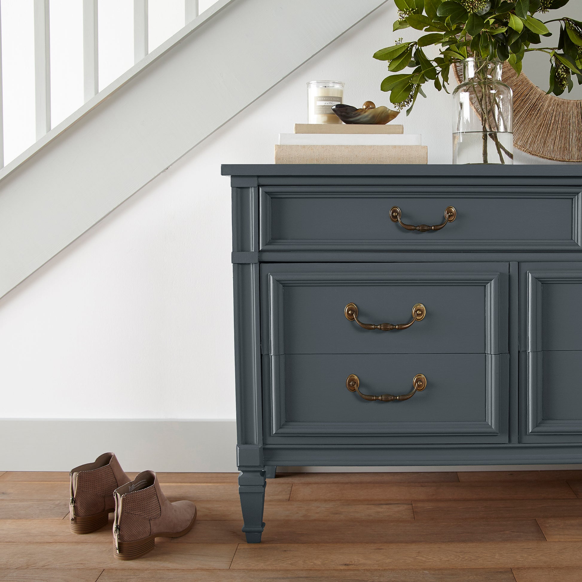 Almost black with dark blue undertones door and cabinet paint named arches shown painted on entryway cabinet