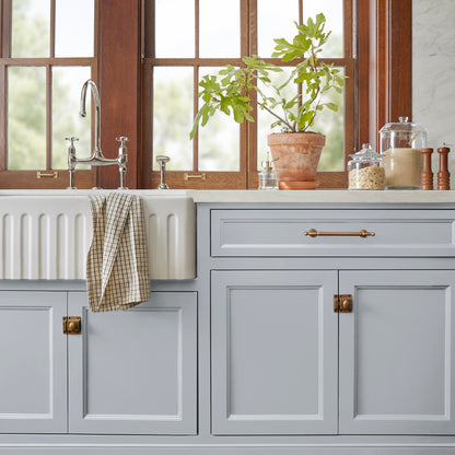 Soft cool gray door and cabinet paint named cement pots shown painted on kitchen cabinet  