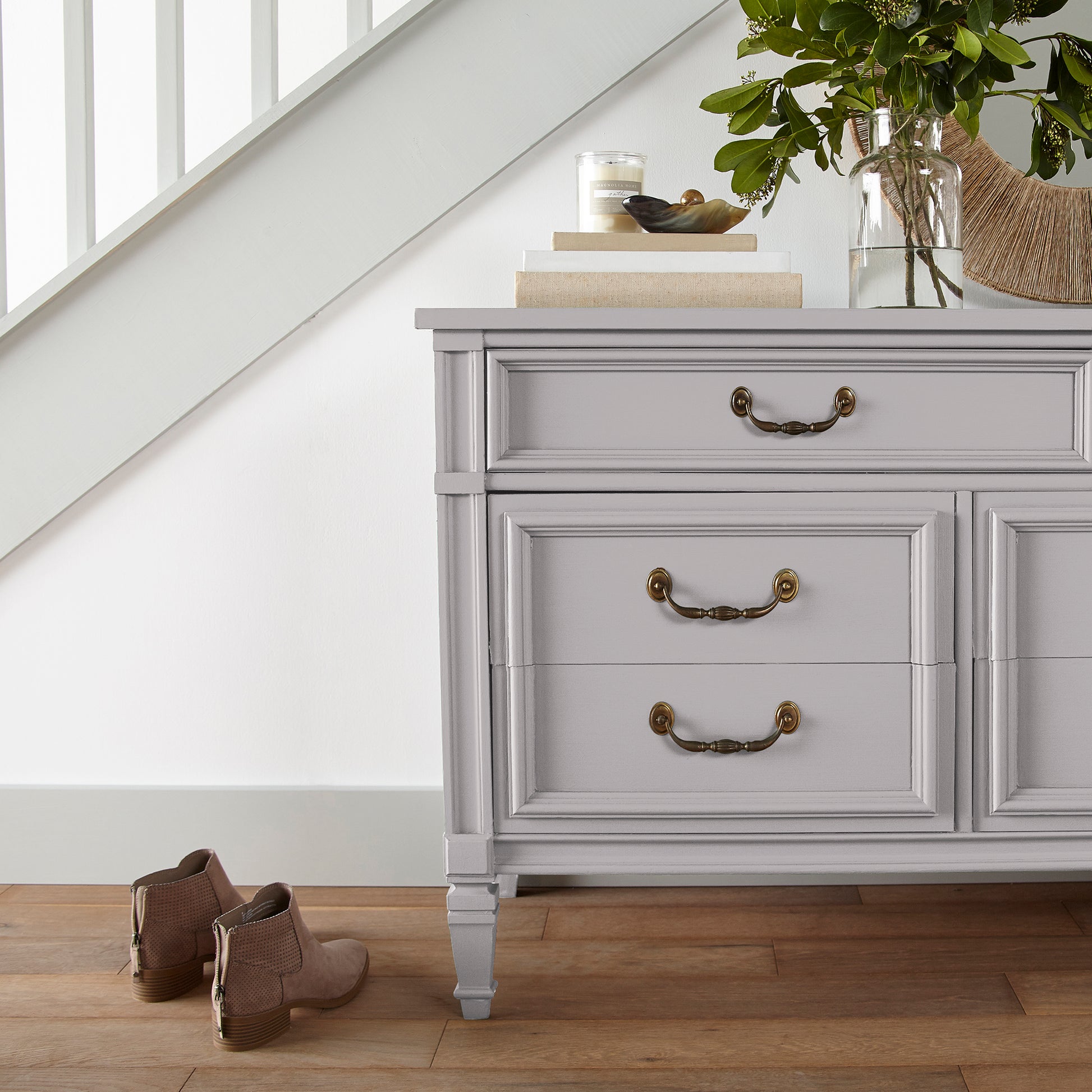 A muted lavender door and cabinet paint named in bloom shown painted on entryway cabinet