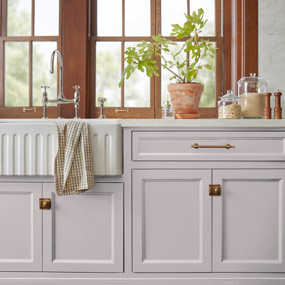 A muted lavender door and cabinet paint named in bloom shown painted on kitchen cabinet  