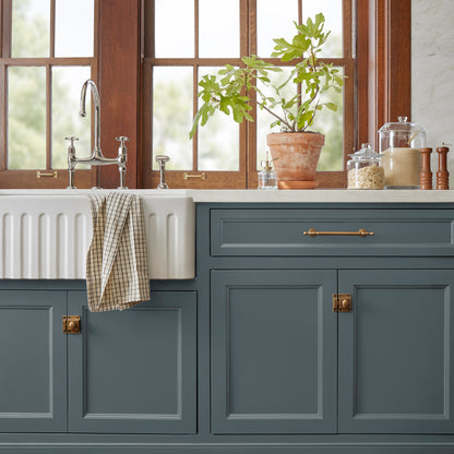 A dark smoky gray with blue undertones door and cabinet paint named coffee nook shown painted on kitchen cabinet 