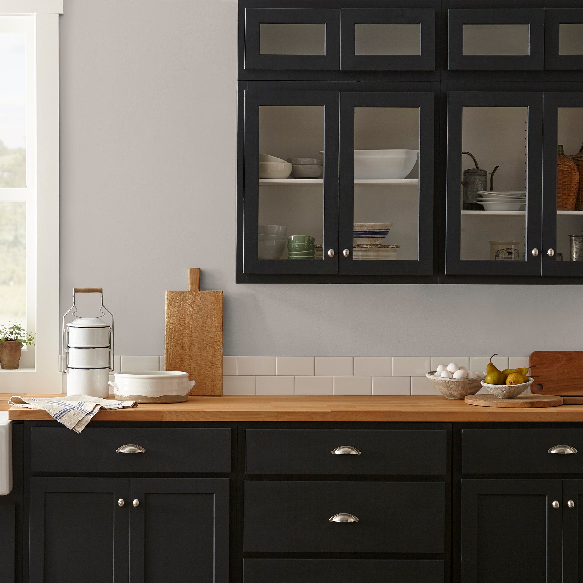Soft tan with notes of gray interior paint named anatolian shown painted on kitchen wall