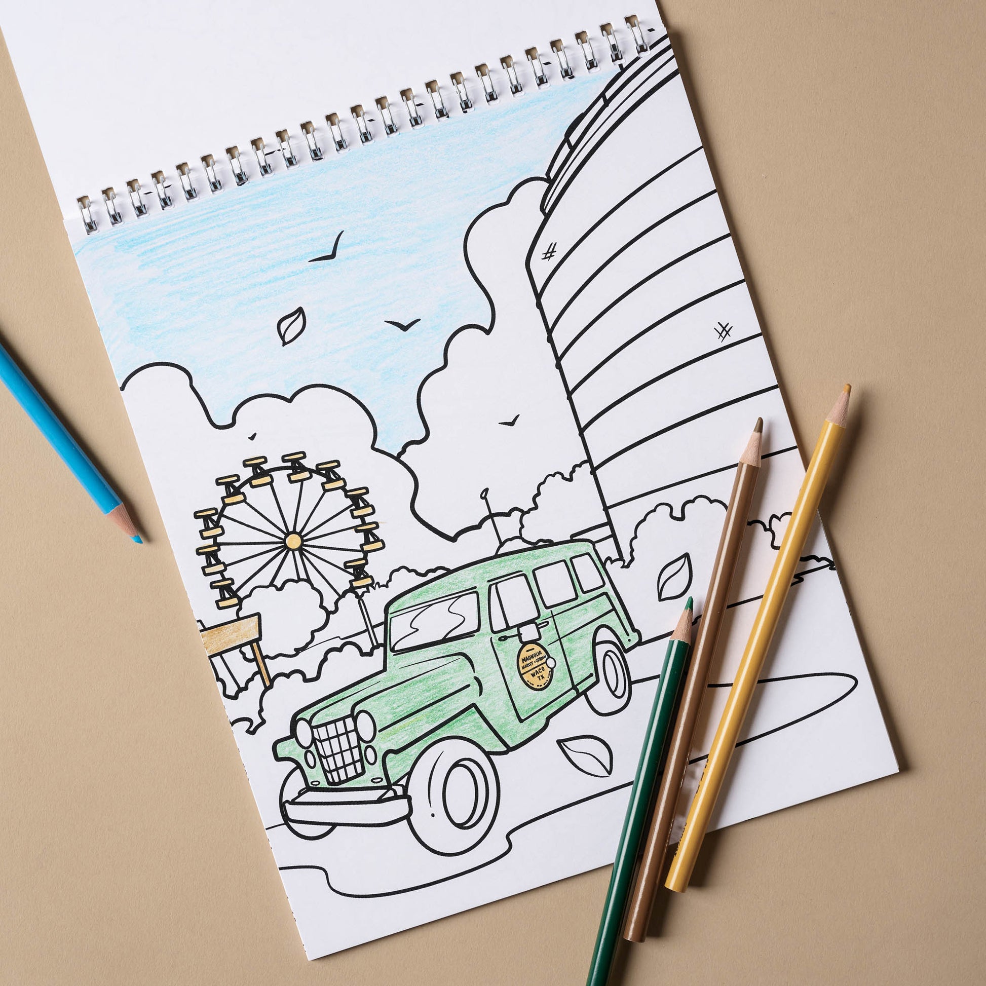 Magnolia Coloring Book open to a page with a car 