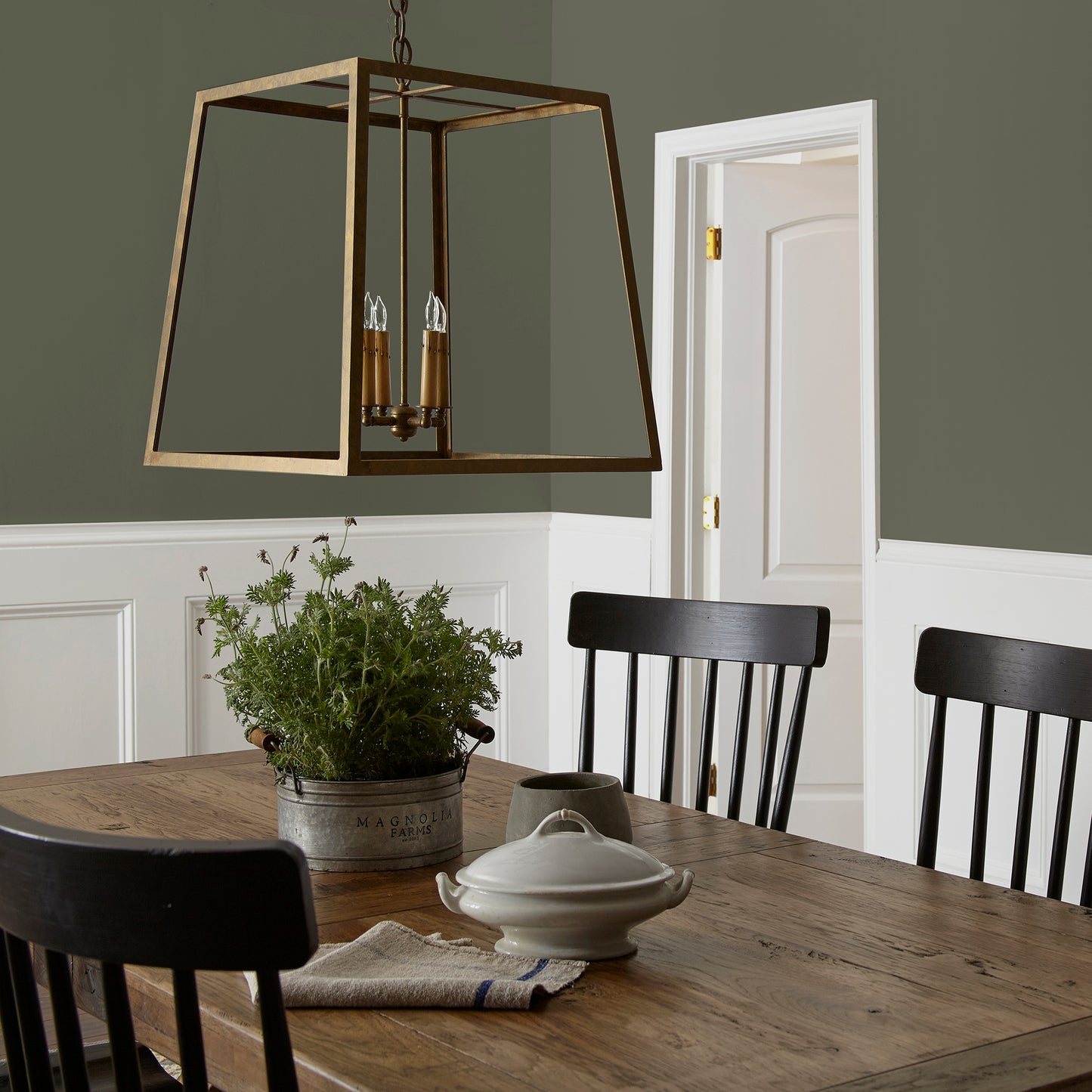 deep olive green interior paint named Step Stool Green shown painted on dining room wall