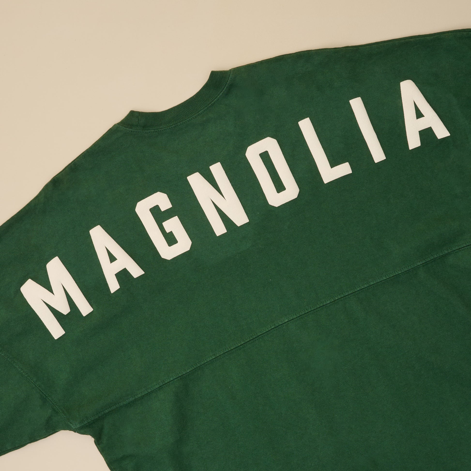 Magnolia Green Spirit Jersey close up back view of Magnolia logo