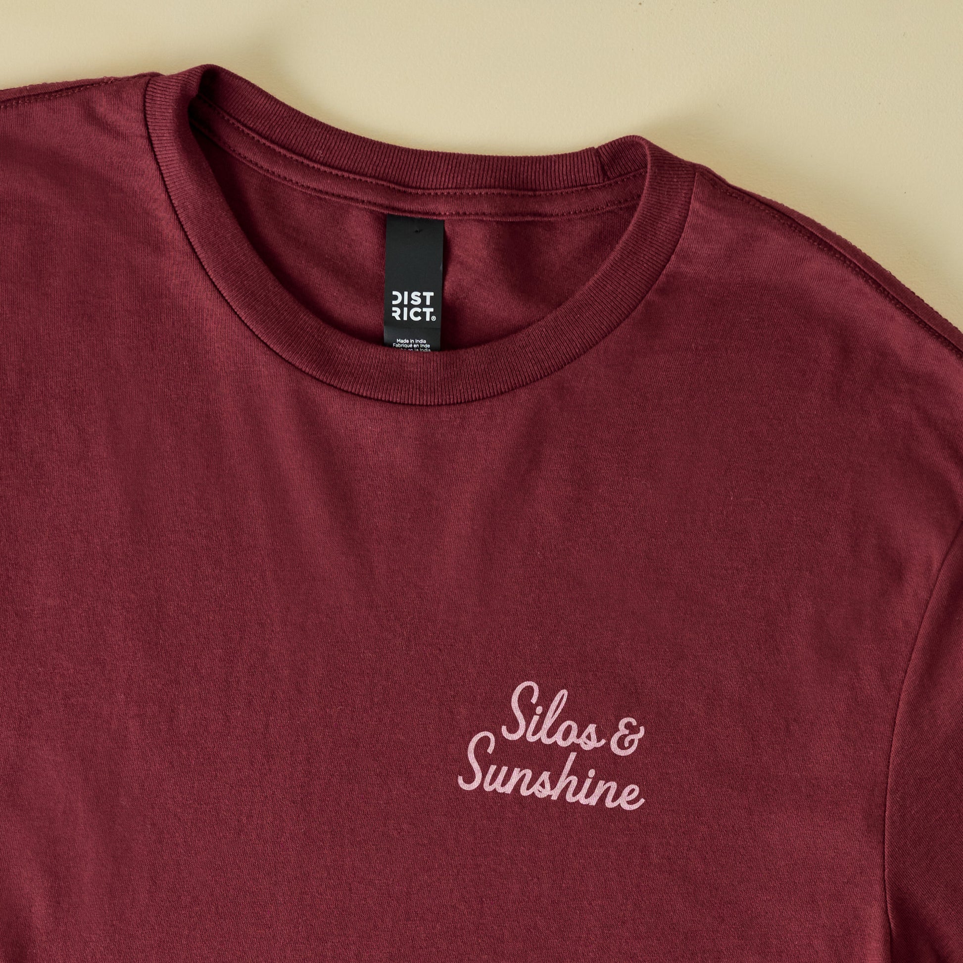 Magnolia Sunshine Maroon Shirt close up of logo 