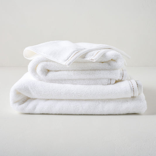 Magnolia White Plush Stitched Edge Towels shown stacked