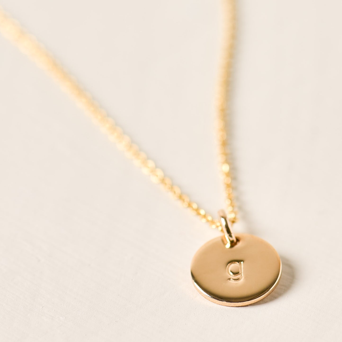 magnolia gold initial disc necklace