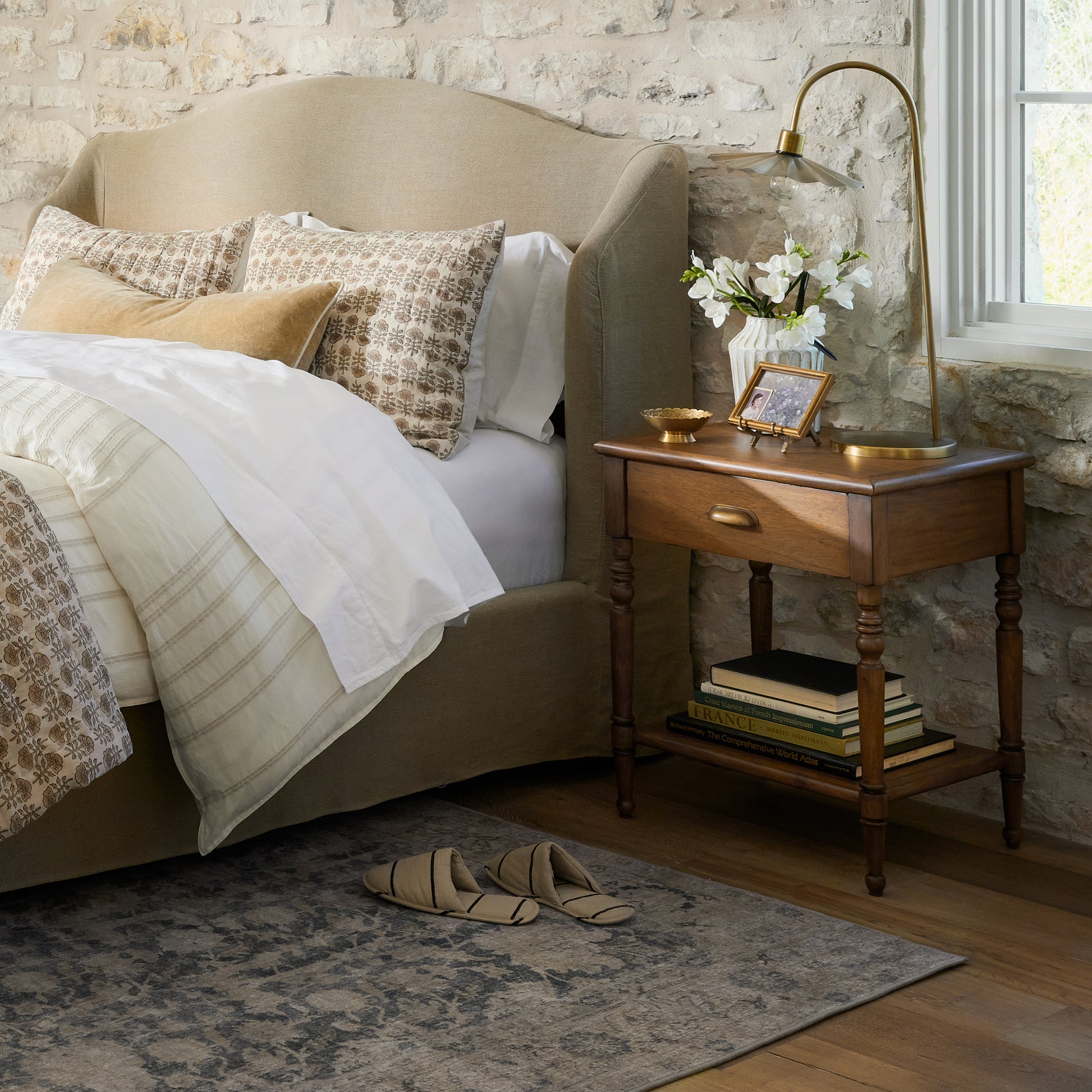 Vera Nightstand next to a bed