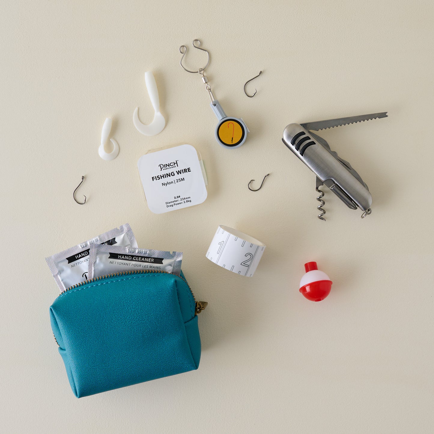 Collection of fishing tools and accessories with blue pouch