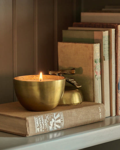 Antique Brass Apple Candle lit up on shelf