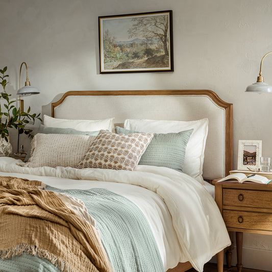 Corinne Upholstered Bed with bedding in a bedroom