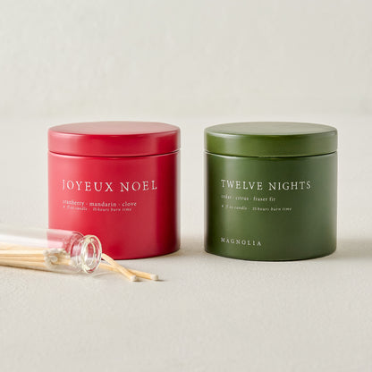 Magnolia Joyeux Noel and Twelve Nights Candle Tin Bundle shown with matches