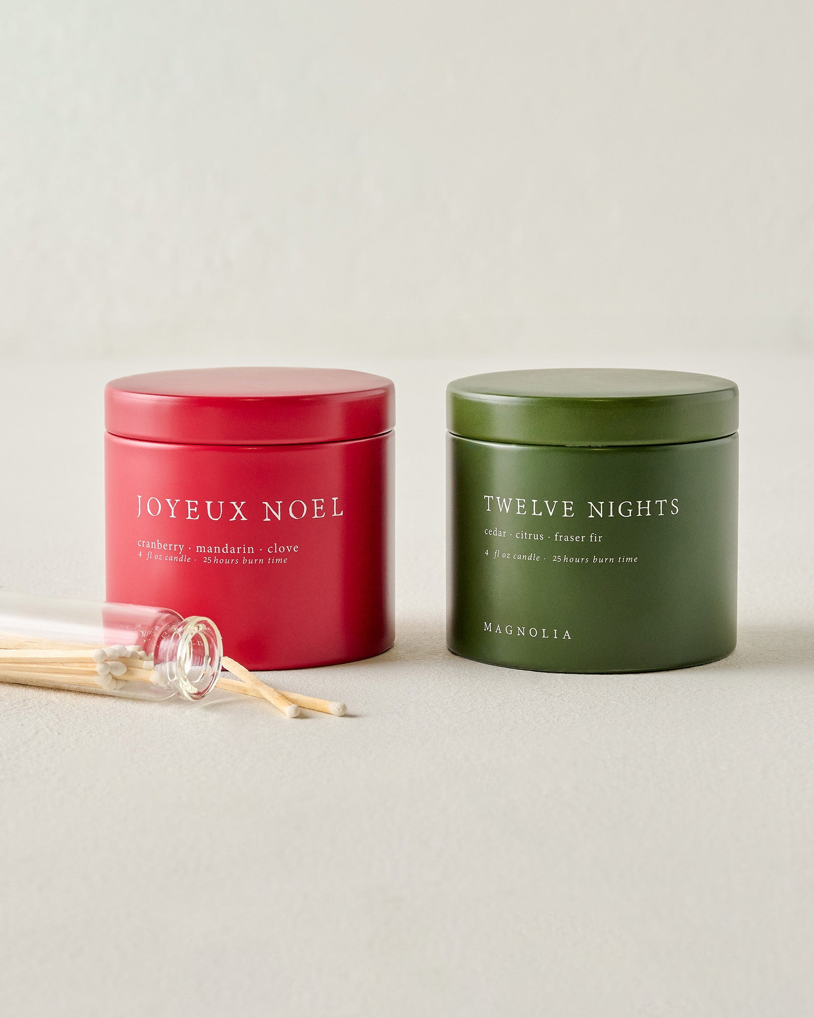 Magnolia Joyeux Noel and Twelve Nights Candle Tin Bundle shown with matches