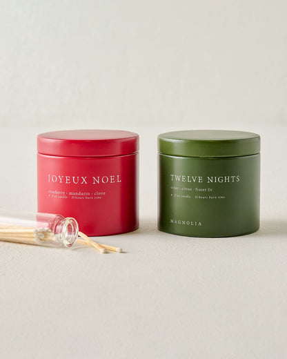 Magnolia Joyeux Noel and Twelve Nights Candle Tin Bundle shown with matches