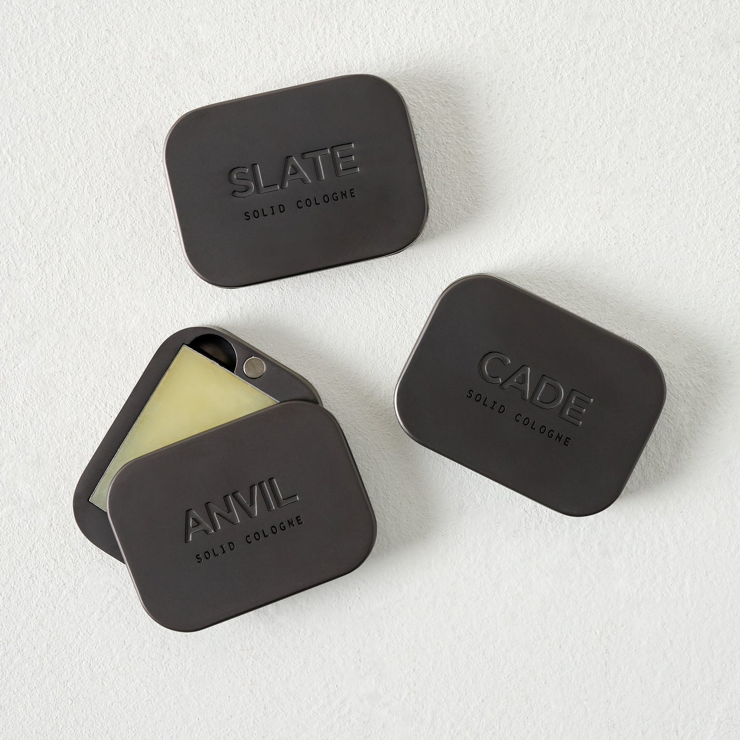 Manready Mercantile Anvil Solid Cologne shown with Cade and Slate solid cologne