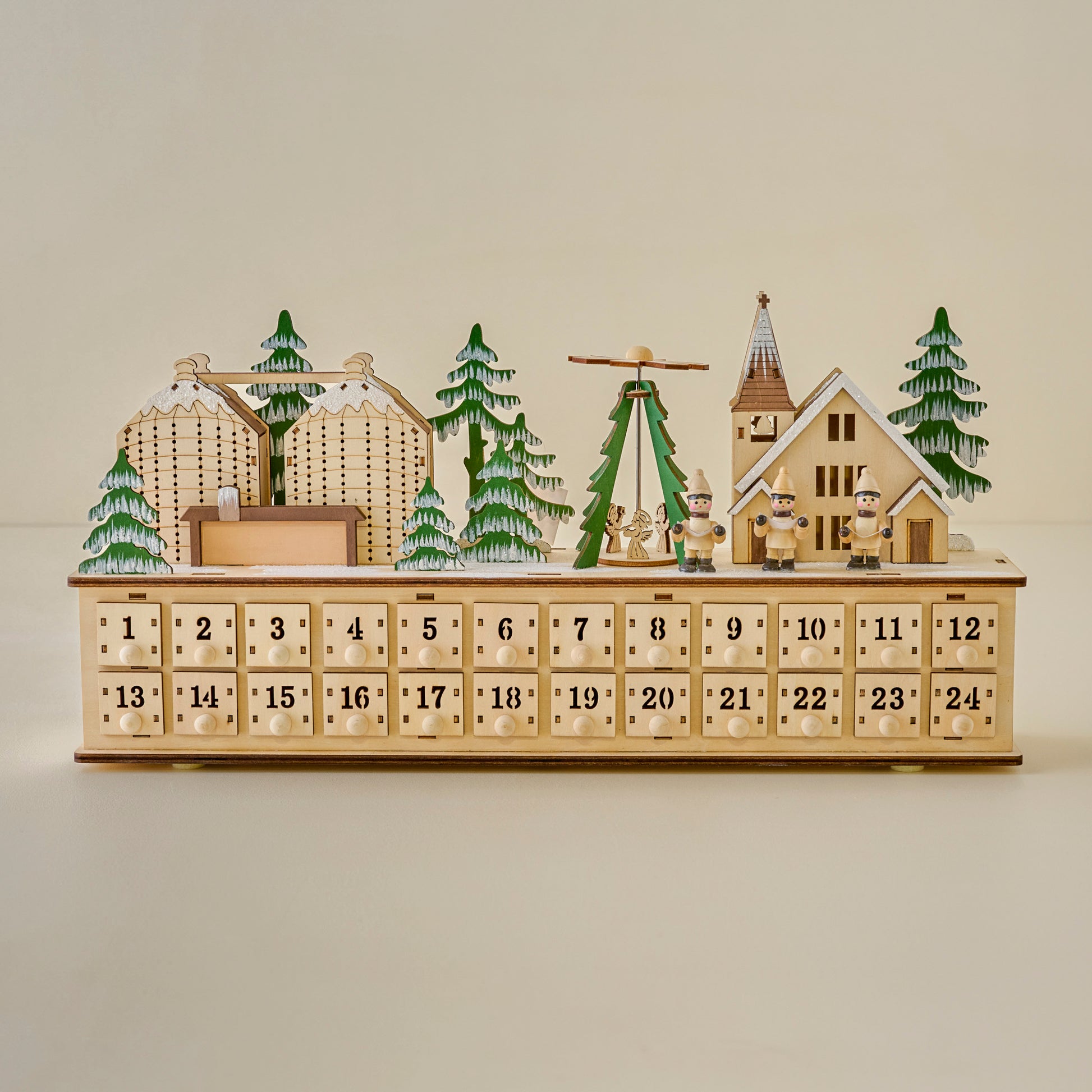 Wooden advent calendar with Christmas village scene on a beige background