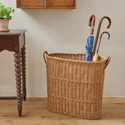 Natural Rattan Console Basket filled with umbrellas in a room
