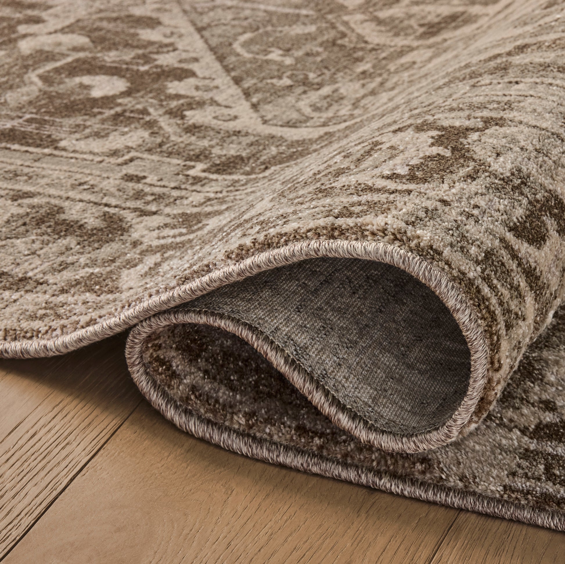 Mona Cocoa Stone Rug close up of rolled rug