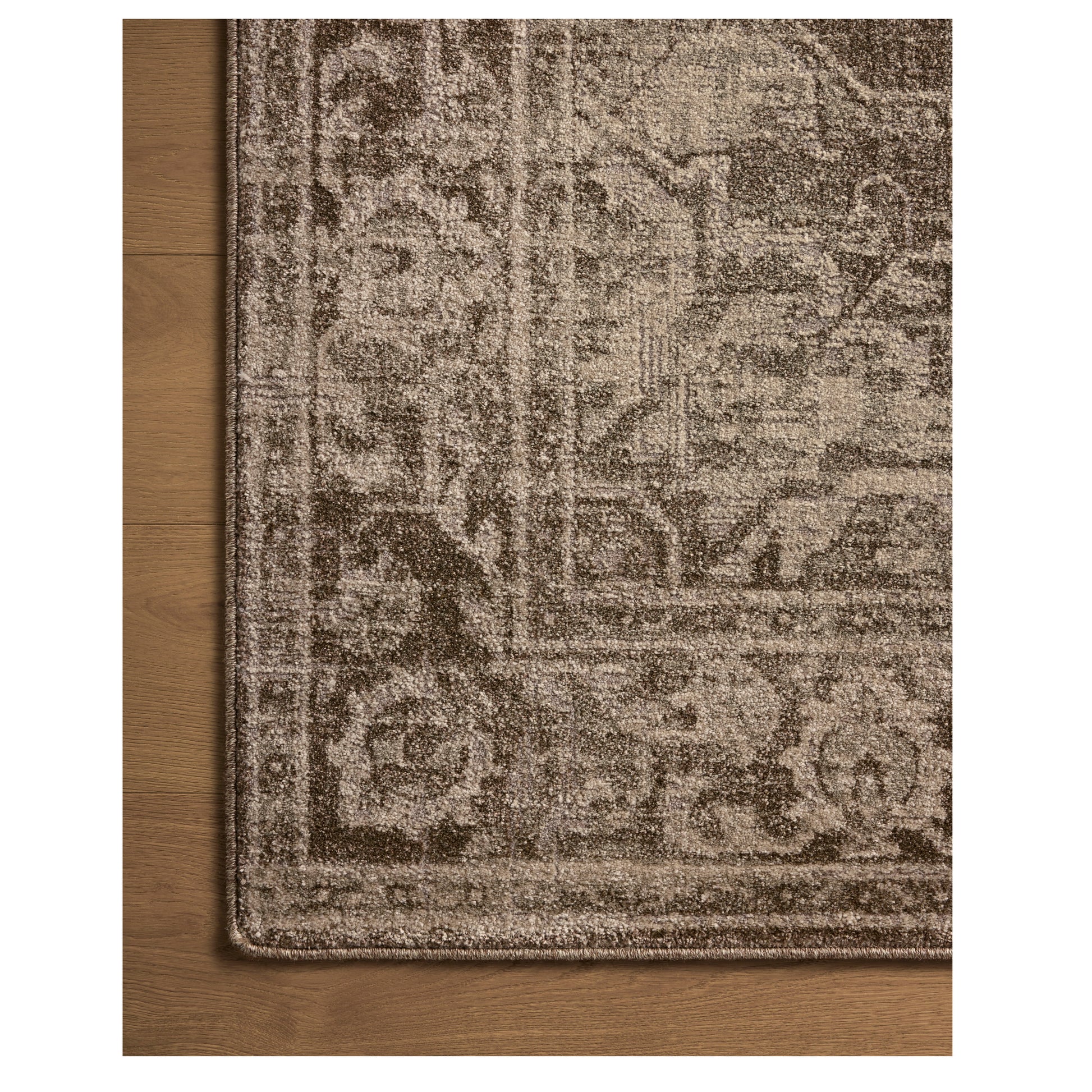 Mona Cocoa Stone Rug close up of rug corner on wood floor