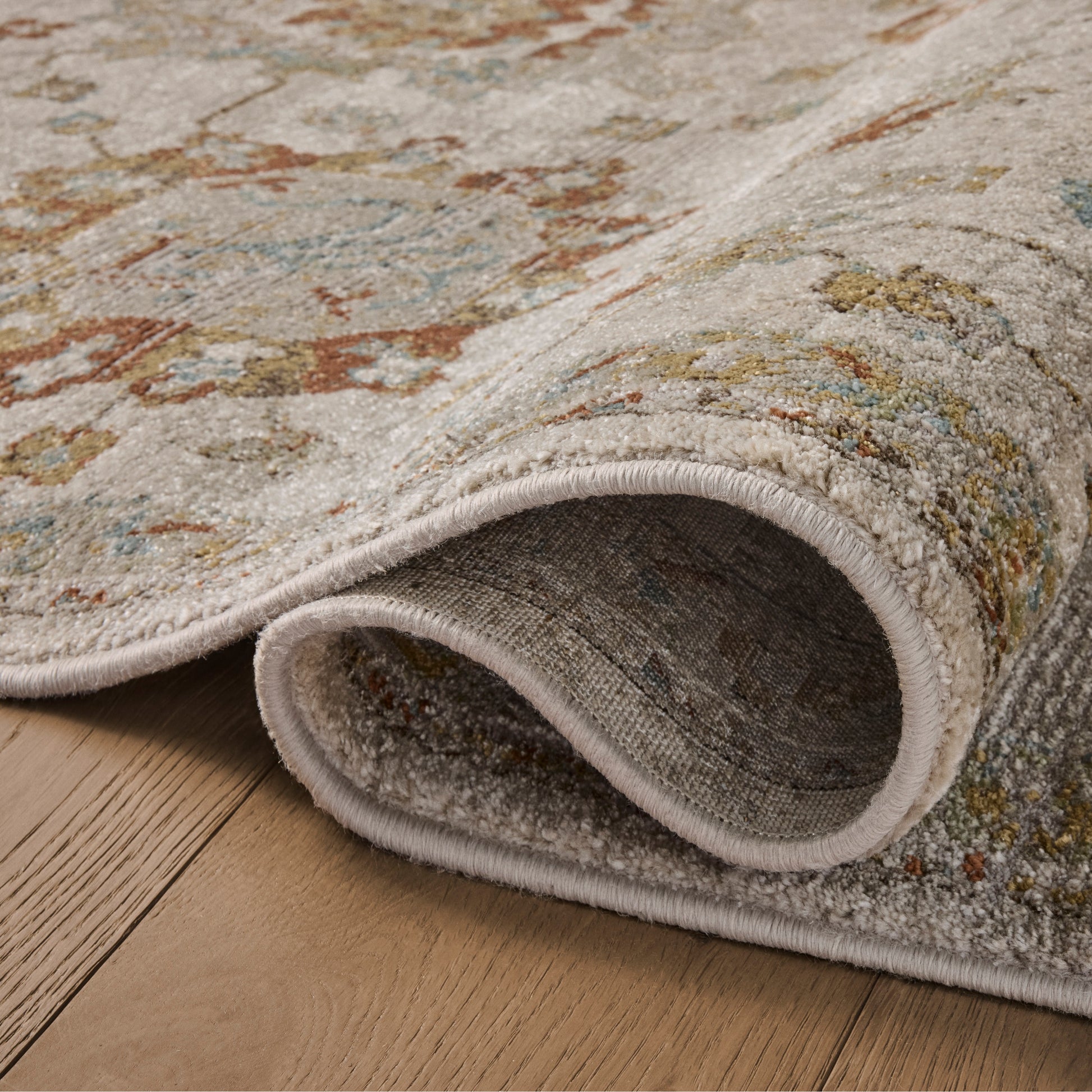 Mona Oatmeal Multi Rug close up of rolled rug